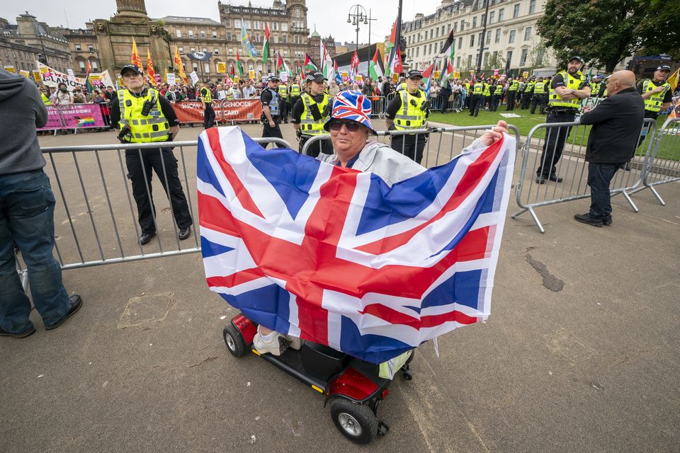 Supporters of a Pro-UK rally endorsed by Tommy Robinson gather in Glasgow’s George Square (Jane Barlow/PA)