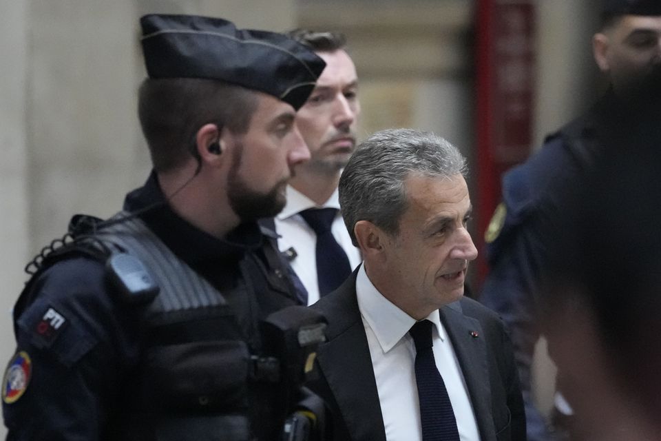 Nicolas Sarkozy arrives at the courtroom for his appeal trial of trying to bribe a magistrate in exchange for information about a legal case in which he was implicated (AP)