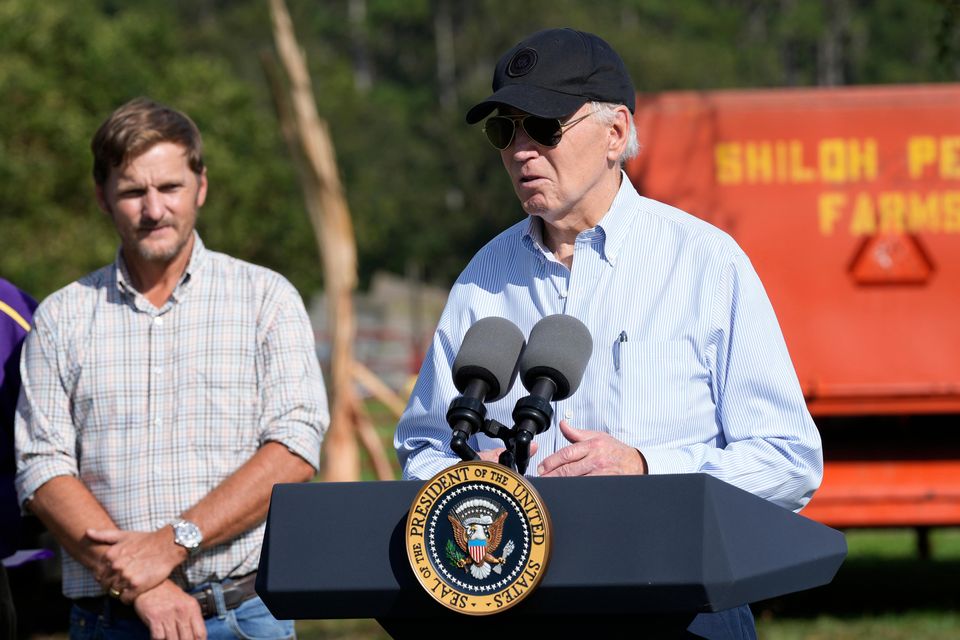 President Joe Biden speaks at Shiloh Pecan Farm as property manager Buck Paulk looks on in Ray City, Georgia as part of Mr Biden’s trip to see areas impacted by Hurricane Helene (Susan Walsh/AP)