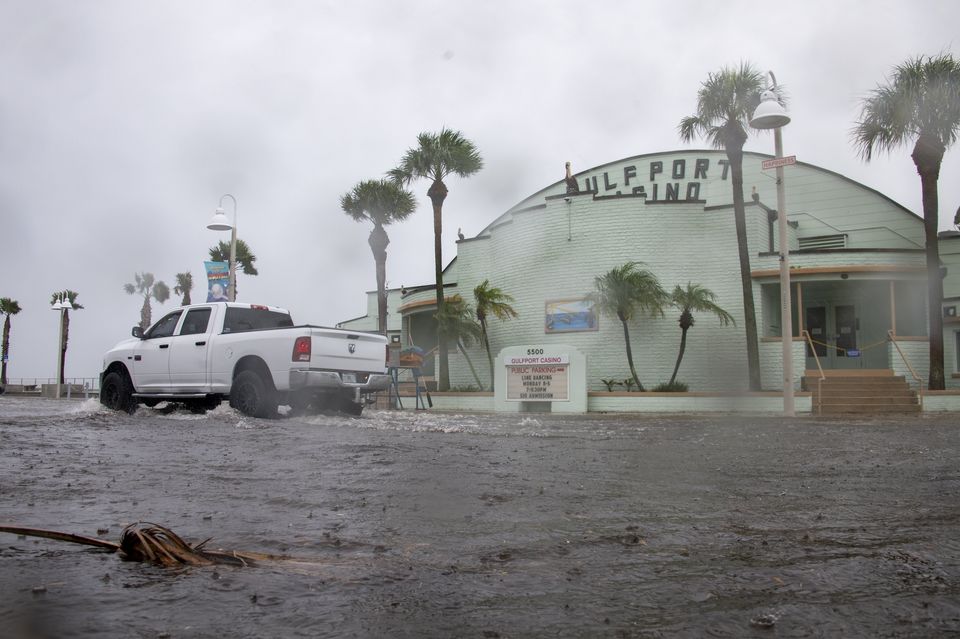 A vehicle drives through a flooded street as Tropical Storm Debby approaches Florida. (Dylan Townsend/Tampa Bay Times via AP)