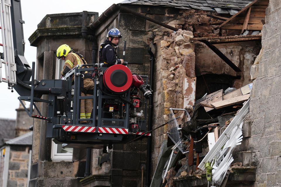 Fire investigators at the scene of the explosion (Andrew Milligan/PA)