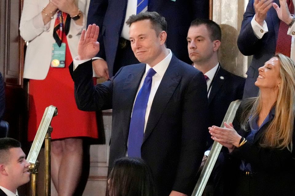 Elon Musk gestures as Mr Trump addresses a joint session of Congress (Alex Brandon/AP)