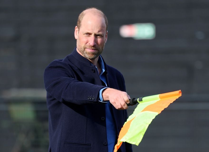 The Prince of Wales waves the linesman’s flag during a mini football game (Chris Jackson/PA)