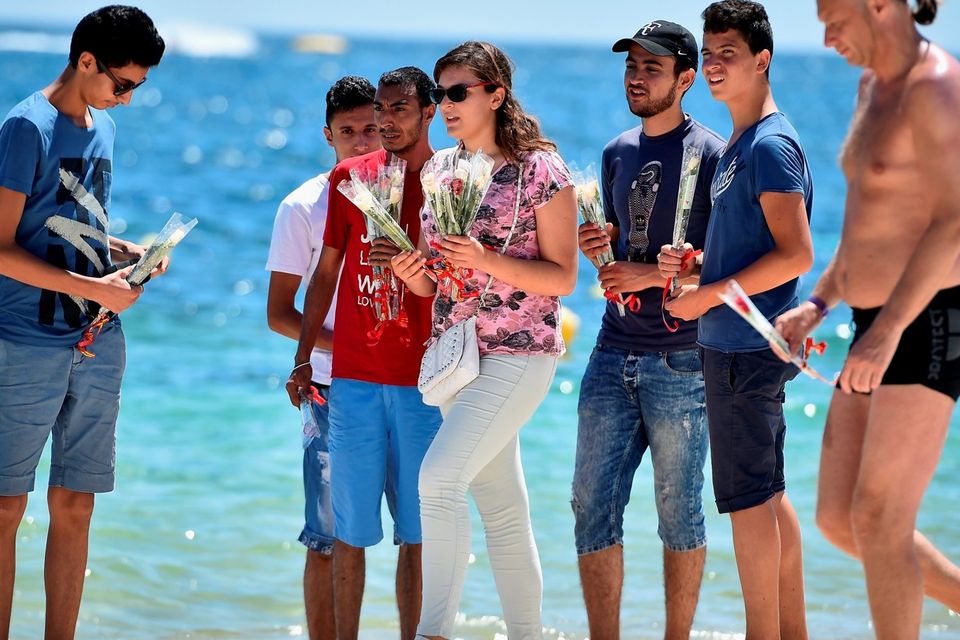 SOUSSE, TUNISIA - JUNE 30:  Holidaymakers lay flowers on Marhaba beach, where 38 people were killed in a terrorist attack last Friday, on June 30, 2015 in Sousse, Tunisia. British police have been deployed to the area as part of one of the biggest counter terror operations since the London bombings on July 7, 2005. (Photo by Jeff J Mitchell/Getty Images)
