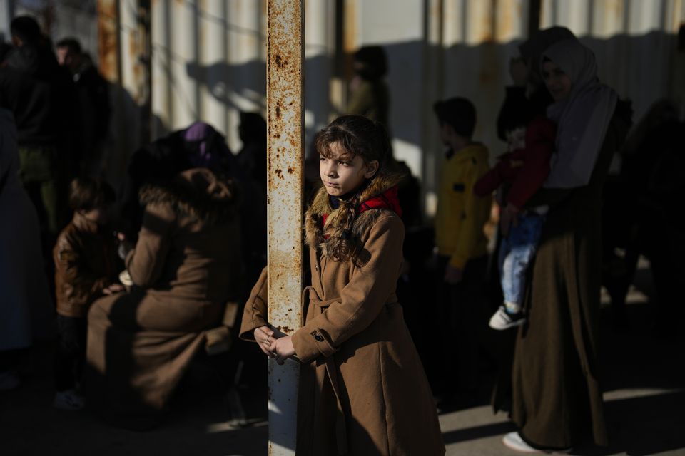 Syrians wait to cross into Syria from Turkey at the Oncupinar border gate, near the town of Kilis, southern Turkey (Khalil Hamra/AP)