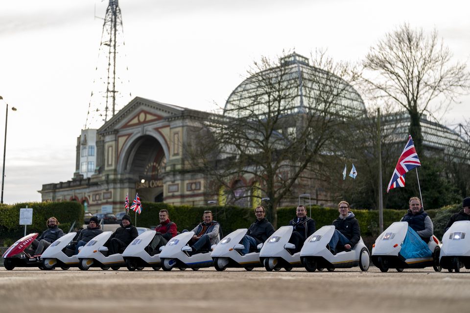 The Alexandra Palace in the background as the C5 enthusiasts line up (Jordan Pettitt/PA)