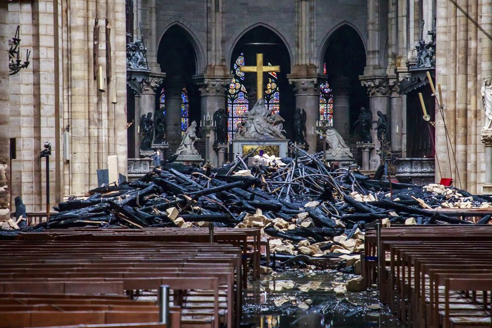 The altar in 2019 surrounded by burnt timbers fallen from the roof (Christophe Petit Tesson, pool via AP)