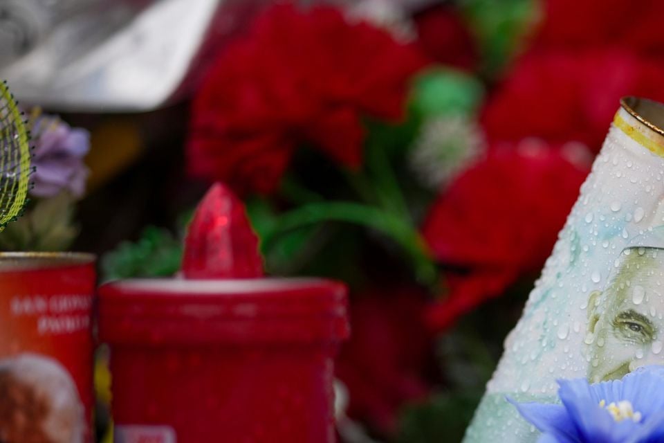 Candles and flowers were left for the pope outside the Agostino Gemelli Polyclinic in Rome (Andrew Medichini/AP)