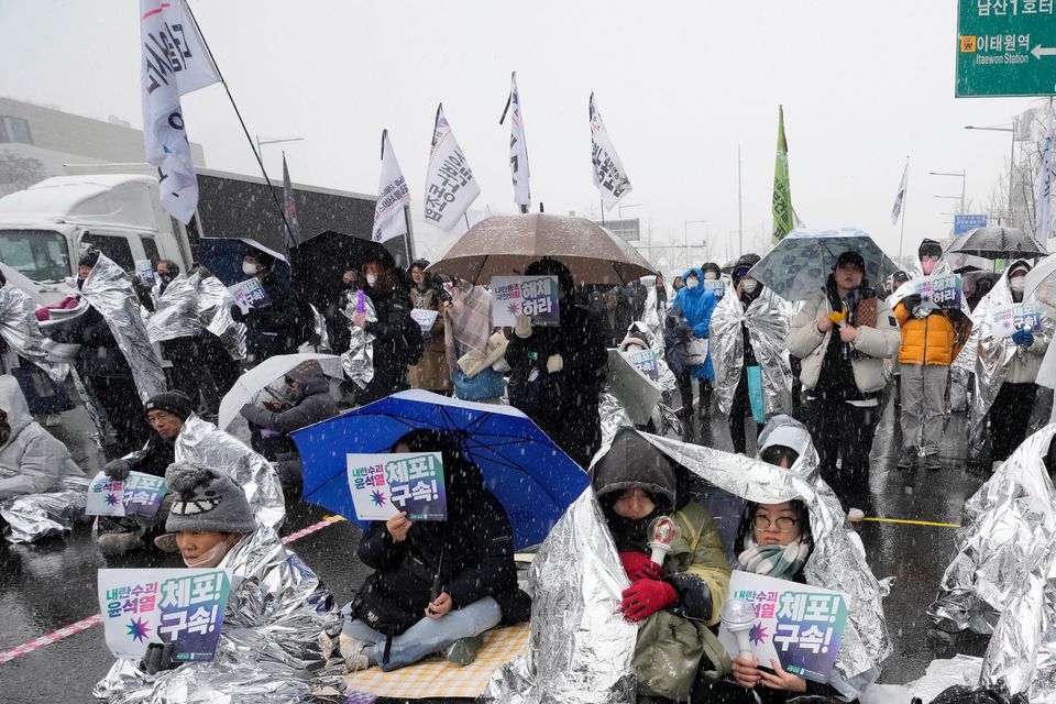 Protesters attend a rally demanding the arrest of impeached South Korean President Yoon Suk Yeol near his presidential residence (Ahn Young-joon/AP)