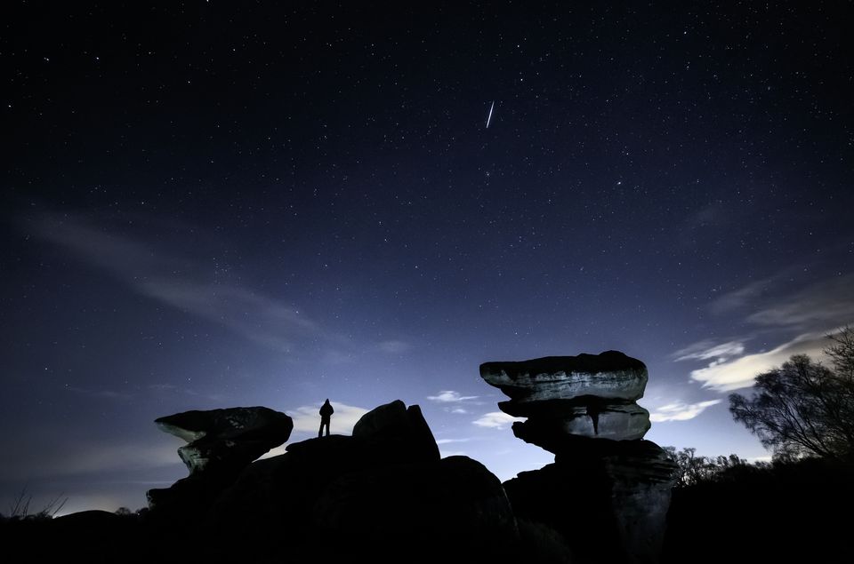 A man watches a meteor during the Geminid meteor shower (PA)