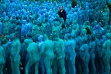 thumbnail: Naked volunteers, painted in blue to reflect the colours found in Marine paintings in Hull's Ferens Art Gallery, prepare to participate in US artist, Spencer Tunick's "Sea of Hull" installation in Queen's Gardens in Kingston upon Hull on July 9, 2016. AFP/Getty Images
