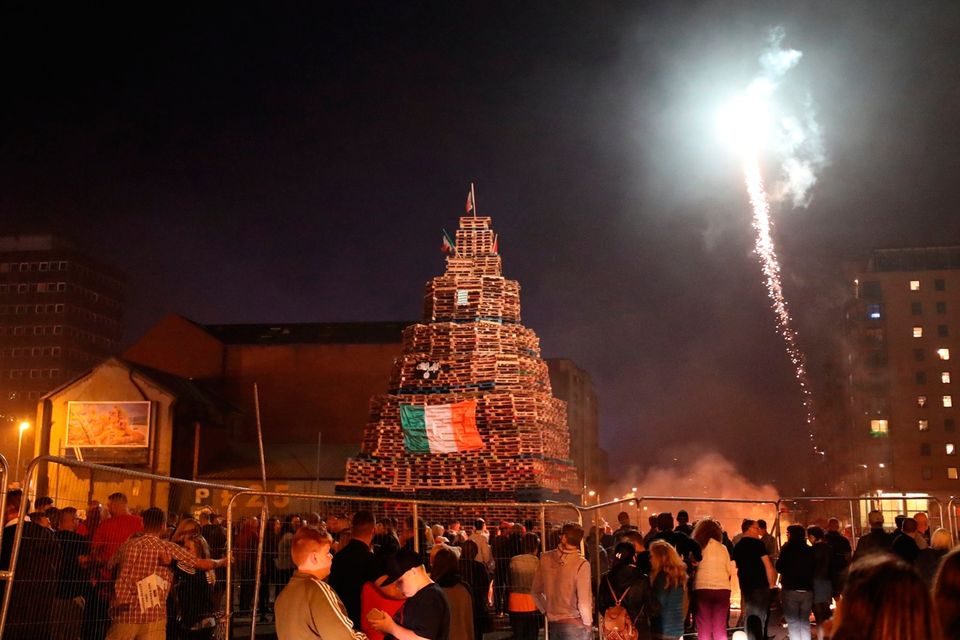 People attend an 11th night Bonfire in the Sandy Row area of Belfast.  PRESS ASSOCIATION Photo. Picture date: Thursday July 12, 2018. Hundreds of bonfires were set to be lit at midnight as part of a loyalist tradition to mark the anniversary of the Protestant King William's victory over the Catholic King James at the Battle of the Boyne in 1690. See PA story ULSTER Bonfires. Photo credit should read: Niall Carson/PA Wire