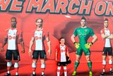 thumbnail: The beautiful game - football fans from around the world -  A young Southampton fan poses for a picture next to a player mural before the Premier League match at St Mary's, Southampton.