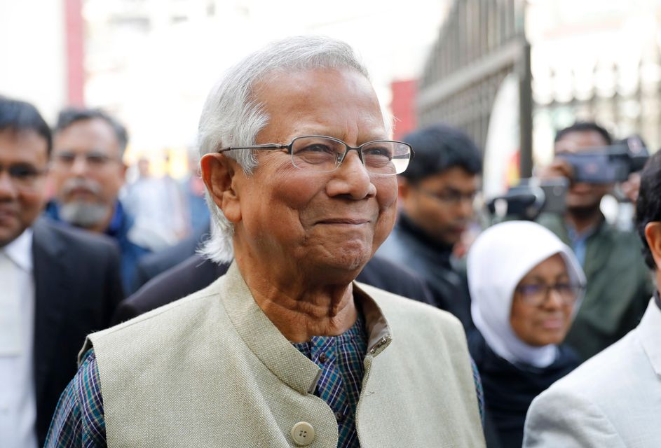 Nobel Peace Prize laureate Muhammad Yunus smiles as he arrives to appear before a labour court in January (Mahmud Hossain Opu/AP)