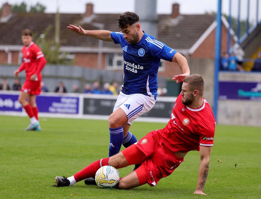 Portadown's Lewis MacKinnon challenges David McDaid