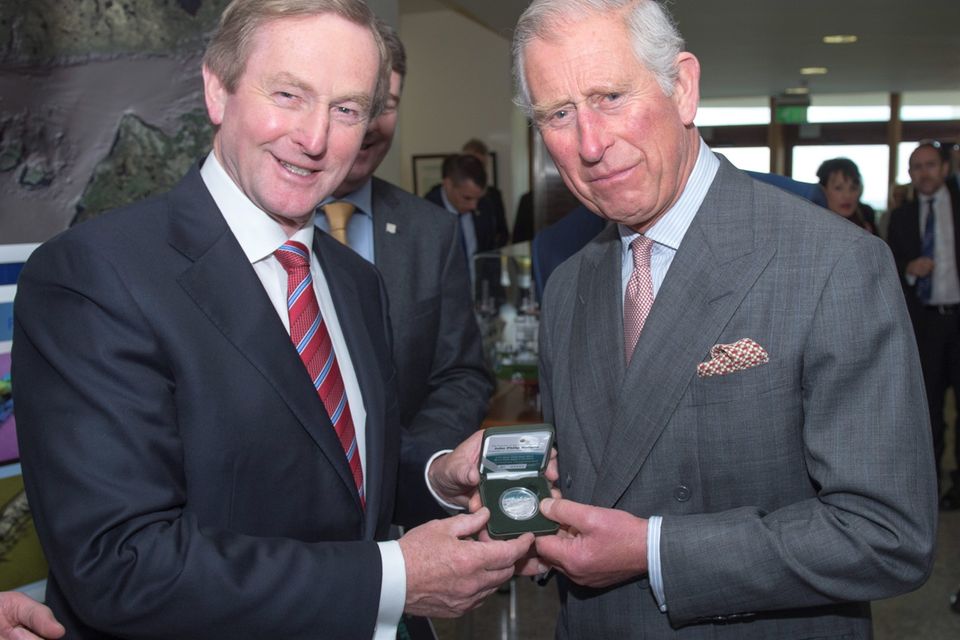 Taoiseach Enda Kenny (left) presents the Prince of Wales (right) with a limited edition commemorative medal in honour of John Philip Holland, Irish inventor of the modern submarine, at the Marine Institute in Galway, on day one of a four day visit to Ireland with the Duchess of Cornwall. PRESS ASSOCIATION Photo. Picture date: Tuesday May 19, 2015. See PA story ROYAL Ireland. Photo credit should read: Arthur Edwards/The Sun/PA Wire