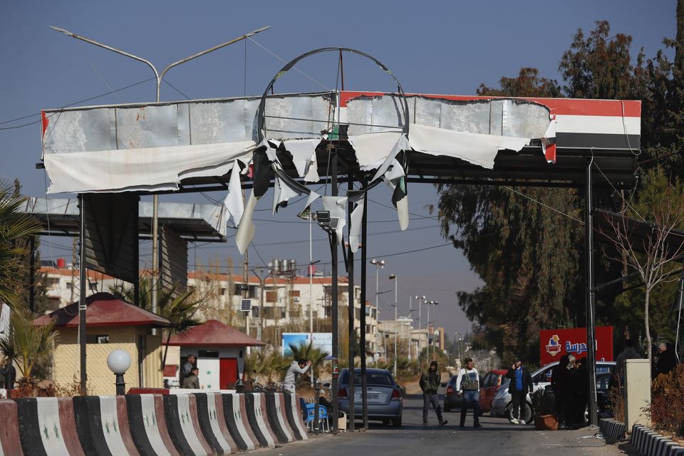 Syrian opposition fighters man a checkpoint in Damascus, Syria (Omar Sanadiki/AP)