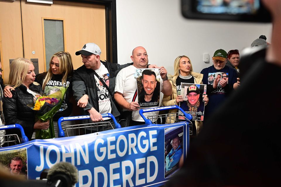 John George's family with father Billy George in the centre pictured after arriving home from Spain at Belfast International Airport on Friday.