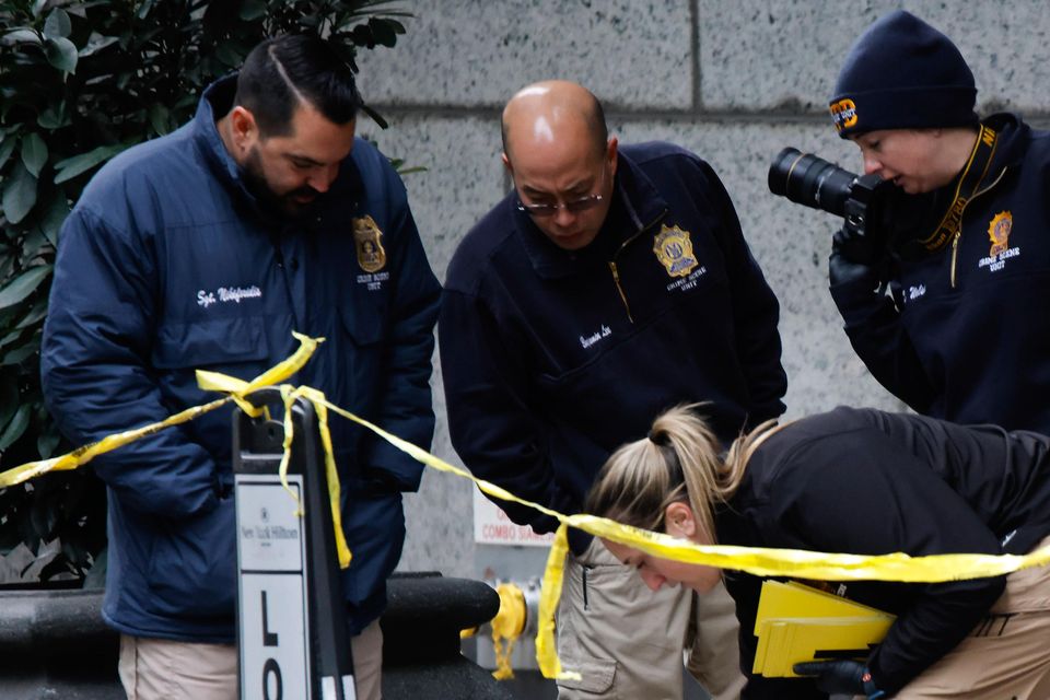 Members of the New York police crime scene unit investigate the scene where Brian Thompson was killed (AP Photo/Stefan Jeremiah)