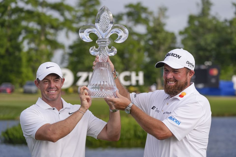 Rory McIlroy and team-mate Shane Lowry celebrate with the trophy after winning the Zurich Classic (Gerald Herbert/AP)