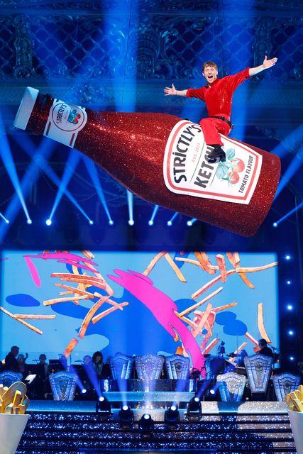 Jamie Borthwick sitting astride the ketchup bottle prop (Guy Levy/BBC/PA)