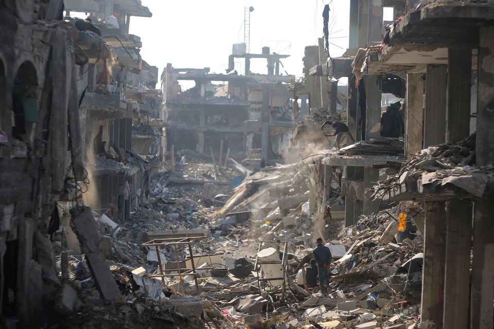 Palestinians inspect their homes destroyed by Israeli attacks in Jabaliya, northern Gaza Strip (Jehad Alshrafi/AP)