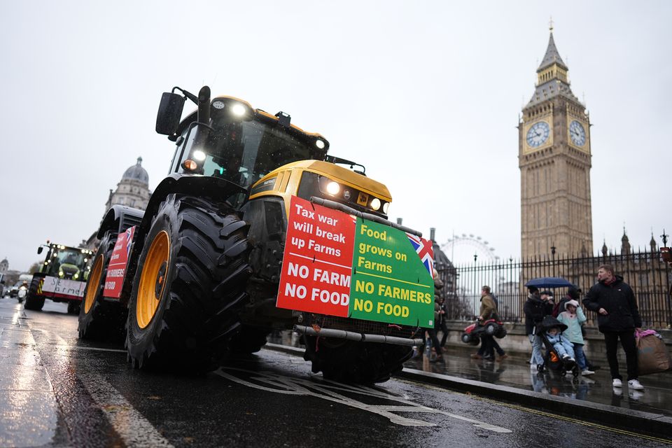 Despite being asked not to bring machinery, farmers drive tractors in Westminster ahead of the rally (Aaron Chown/PA)