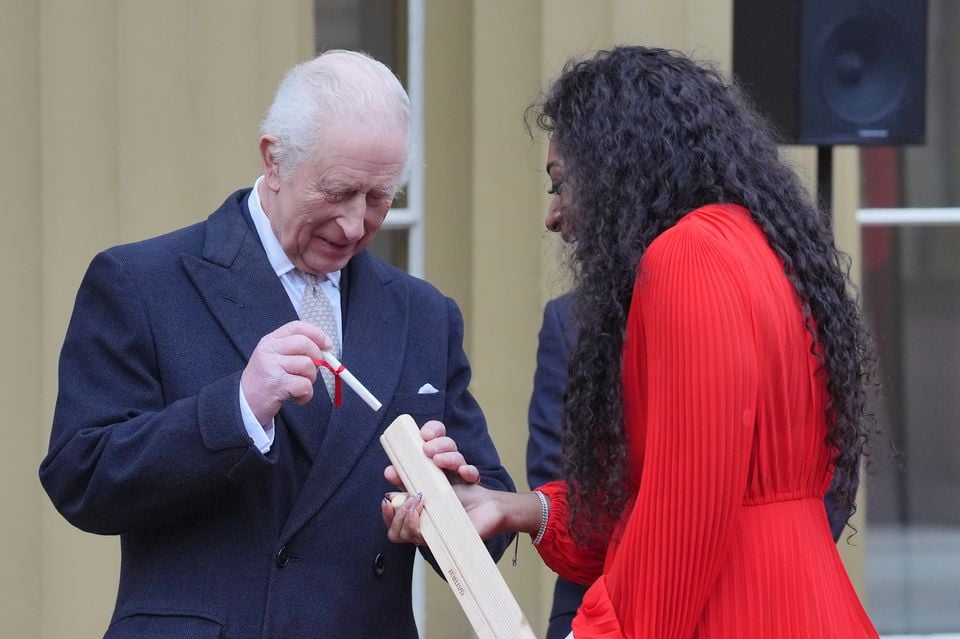 Charles placed his message into the baton with the help of Kadeena Cox (Jonathan Brady/PA)