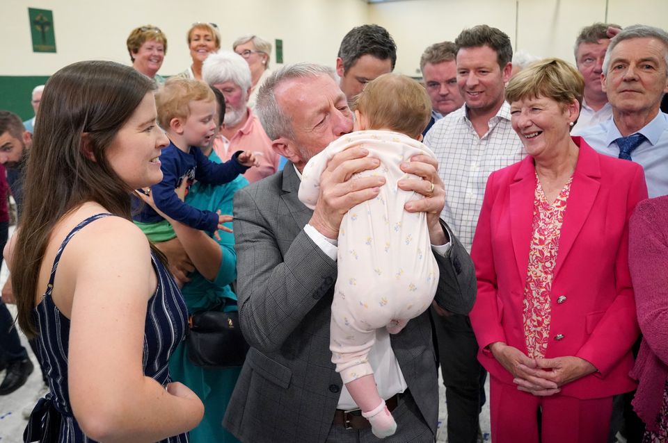 MEP Sean Kelly (centre) kisses his one-year-old granddaughter Hannah-Rose Kelly (Jonathan Brady/PA)