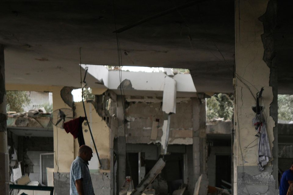 Children walk in the remains of a mosque destroyed by an Israeli airstrike in Deir al-Balah on Sunday (Abdel Kareem Hana/AP)