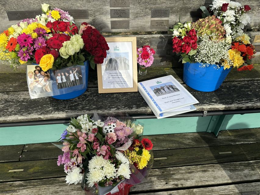 Flowers and cards have been left at a pier in Somerset where One Direction filmed a music video (Eliza Goadby/PA)