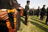thumbnail: National Security Guard commandoes wait to pay floral tribute near the coffin of commando Gajendra Singh, in New Delhi, India, Saturday, Nov. 29,  2008. Indian commandos killed the last remaining gunmen holed up at a luxury Mumbai hotel Saturday, ending a 60-hour rampage through India's financial capital by suspected Islamic militants that killed people and rocked the nation. (AP Photo/Mustafa Quraishi)