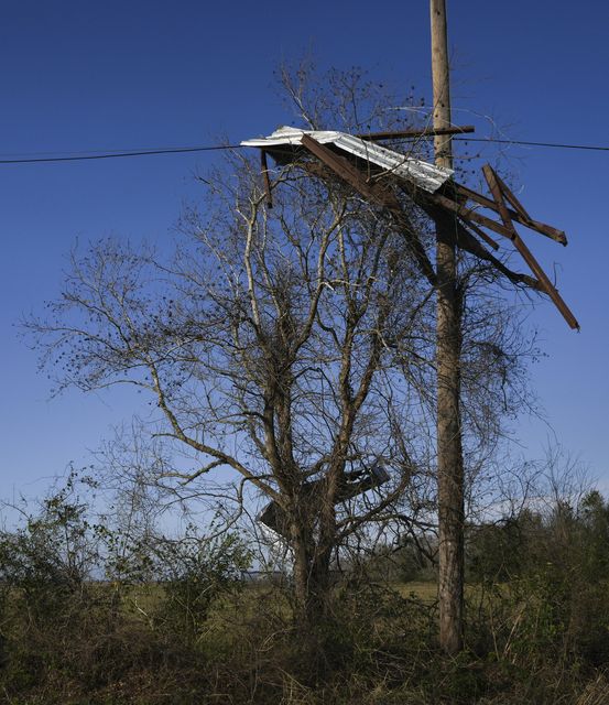 Debris clings to power lines following a tornado that went through Katy, Texas (Elizabeth Conley/Houston Chronicle via AP)