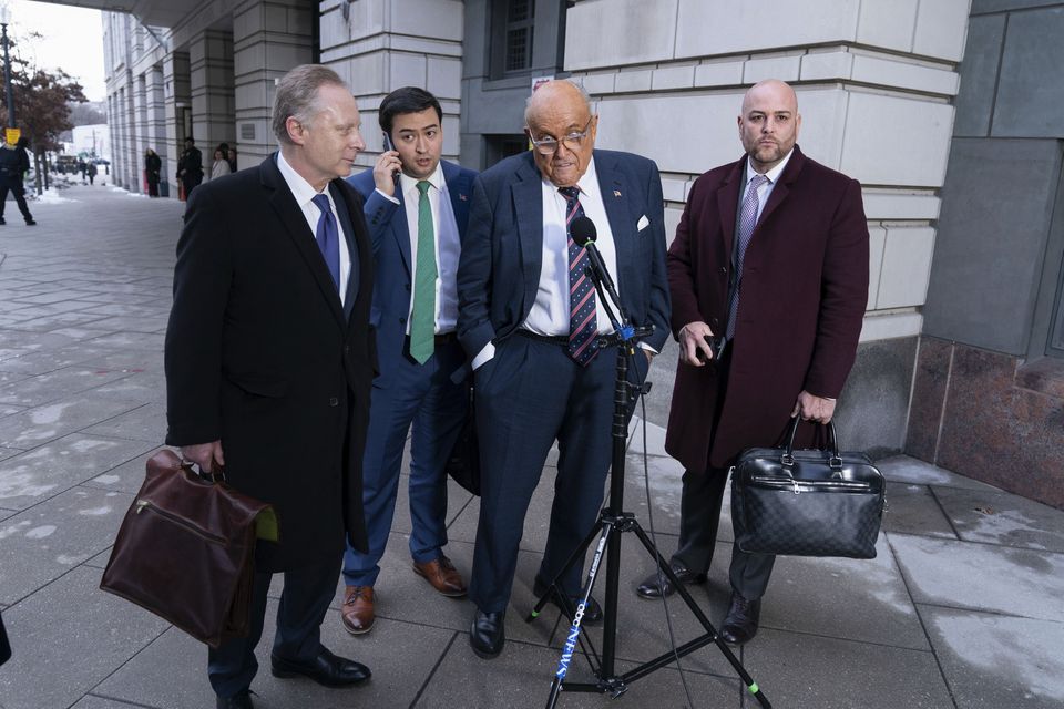 Rudy Giuliani, second from right, with his lawyers outside court on January 10 (Jose Luis Magana/AP)