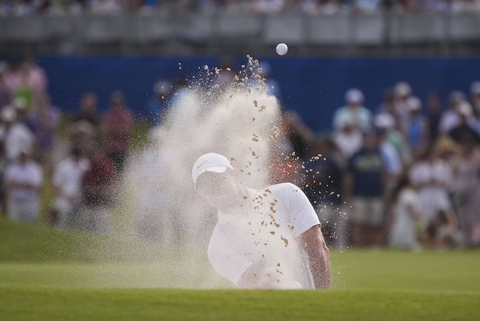 Rory McIlroy hits out of the sand on to the 18th green during a play-off for the Zurich Classic (Gerald Herbert/AP)