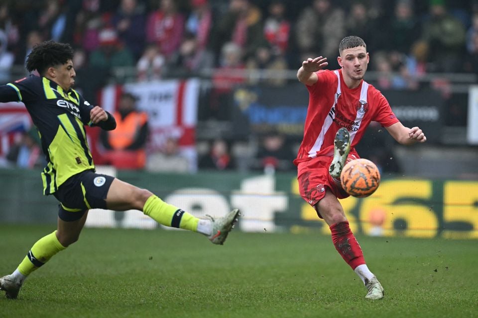 Leyton Orient's Jamie Donley up against Rico Lewis of Manchester City at Gaughan Group Stadium, Brisbane Road (Photo by JUSTIN TALLIS / AFP)