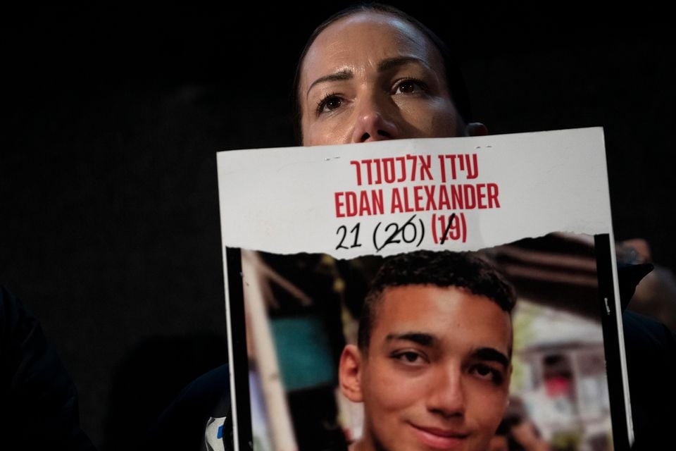 Yael Alexander holds a poster of her son, Edan, who was taken hostage by Hamas militants (Maya Alleruzzo/AP)