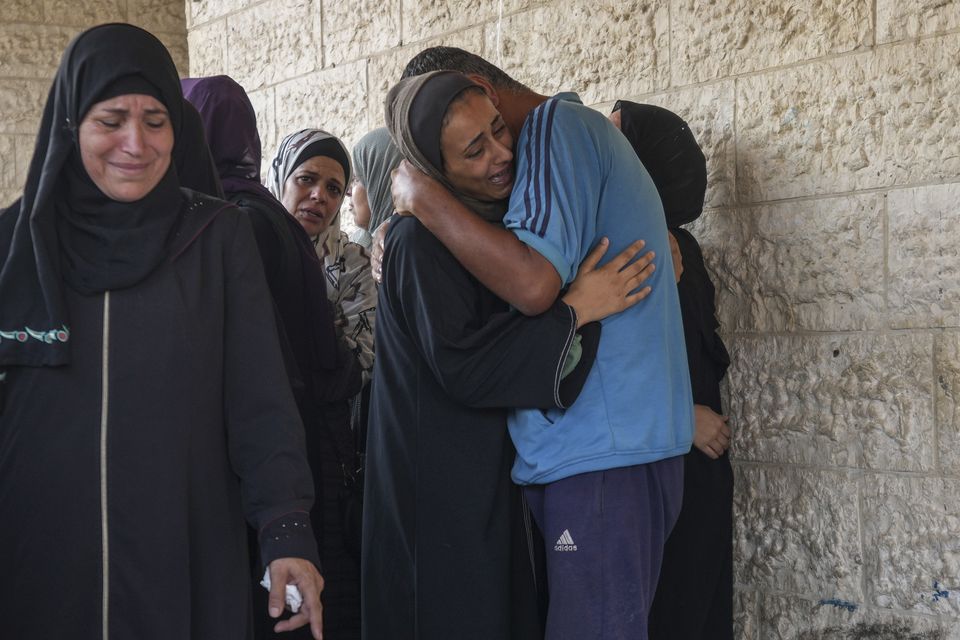 Palestinians grieve at the funeral for more than 15 people killed in an Israeli strike, at Al-Aqsa Martyrs Hospital in Deir al-Balah (AP Photo/Abdel Kareem Hana)