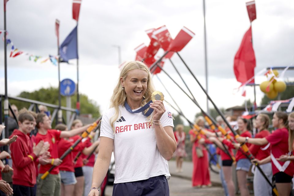 Members of Bann Rowing Club in Coleraine, Northern Ireland, welcome home Team GB women’s quadruple sculls gold medal winner, Hannah Scott  (Niall Carson/PA)