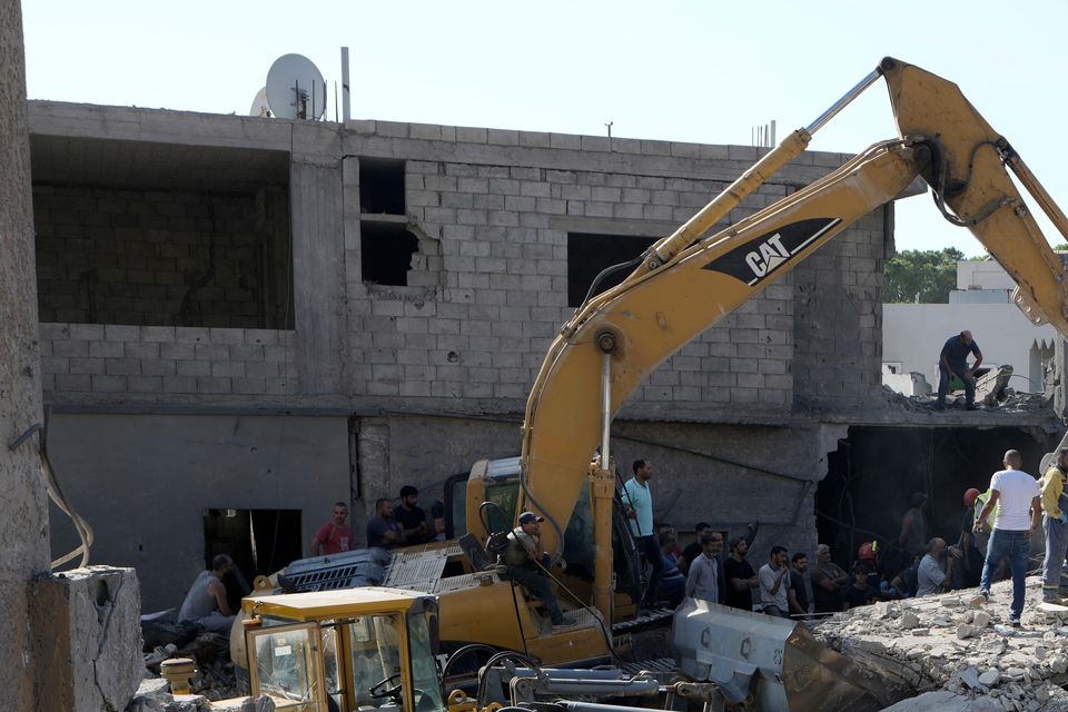 Emergency workers arrive at the scene of an Israeli airstrike in the town of Maisara, north of Beirut, on Wednesday (Bilal Hussein/AP)