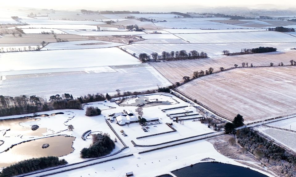 A man-made, fish-shaped loch near Inverurie, Aberdeenshire, is surrounded by snow and ice (Jane Barlow/PA)