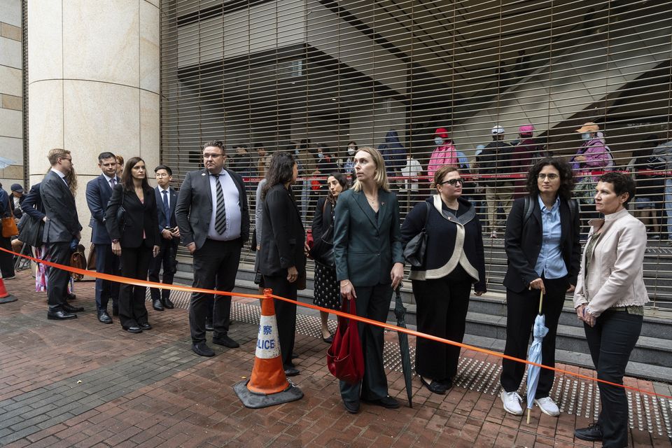 Representatives from different consulates waited in line outside the court (Chan Long Hei/AP)