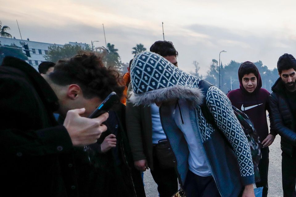 Syrians celebrate the arrival of opposition fighters as they step on a picture of Syrian President Bashar Assad in Damascus (Omar Sanadiki/AP)