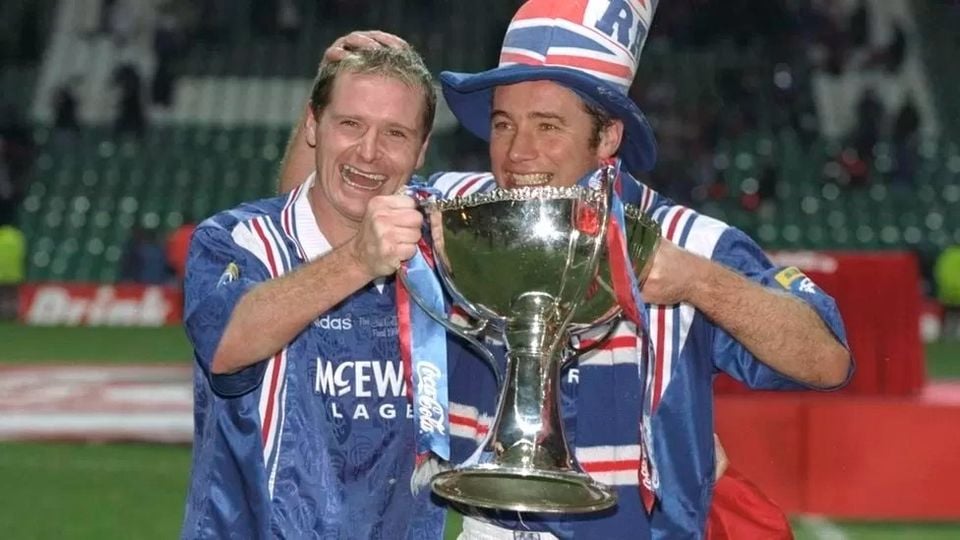 Paul Gascoigne and teammate Ally McCoist pose with the trophy after Rangers won the Scottish Coca Cola Cup. Credit - Getty Images