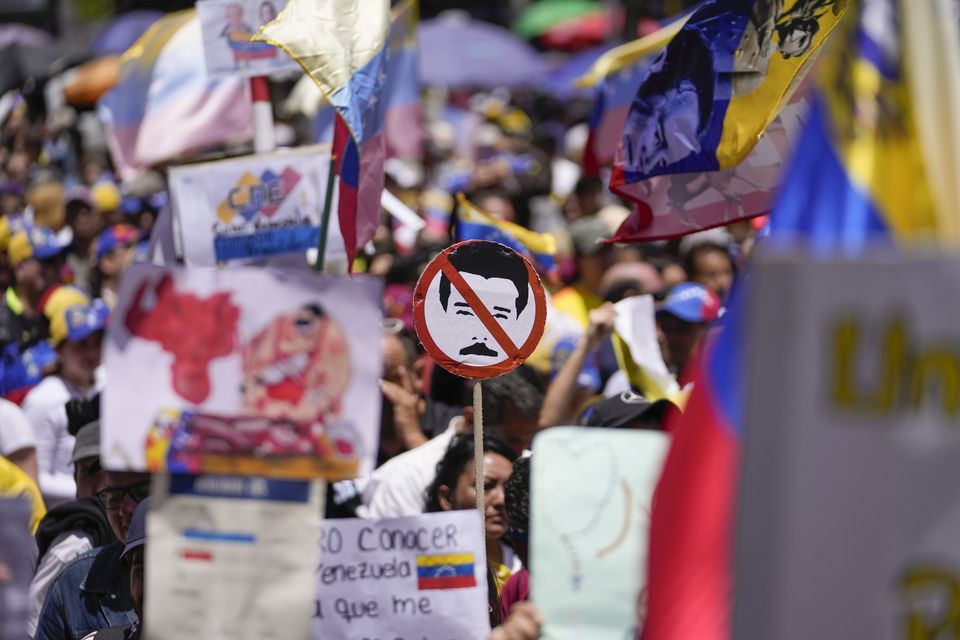 The protesters insisted the opposition candidate comfortably won the vote (Matias Delacroix/AP)