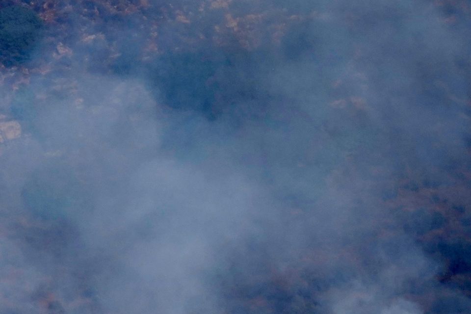 Flames and smoke rise from an Israeli airstrike on the Mahmoudieh mountain, as seen from Marjayoun town, south Lebanon (Hussein Malla/AP)