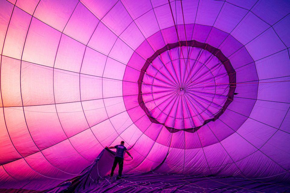 A balloon pilot checks the rigging during pre-flight inflation checks (Ben Birchall/PA)