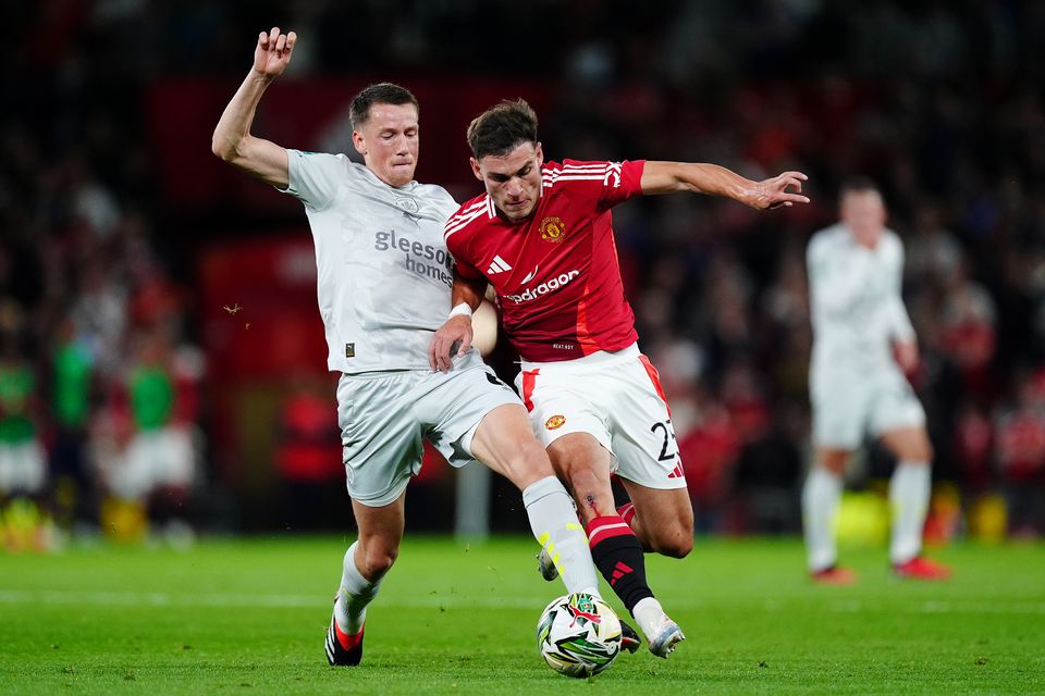 Barnsley’s Mael de Gevigney (left) and Manchester United midfielder Manuel Ugarte battle for the ball during Tuesday’s Carabao Cup clash (Mike Egerton/PA)