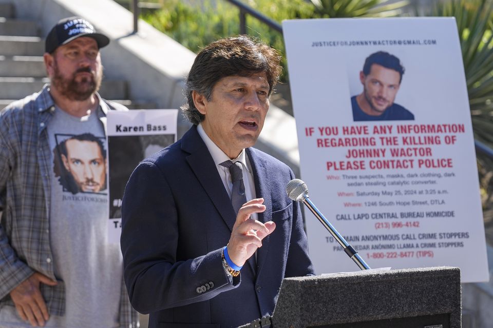 Los Angeles council member Kevin de Leon surrounded by friends of the late actor Johnny Wactor (Damian Dovarganes/AP)