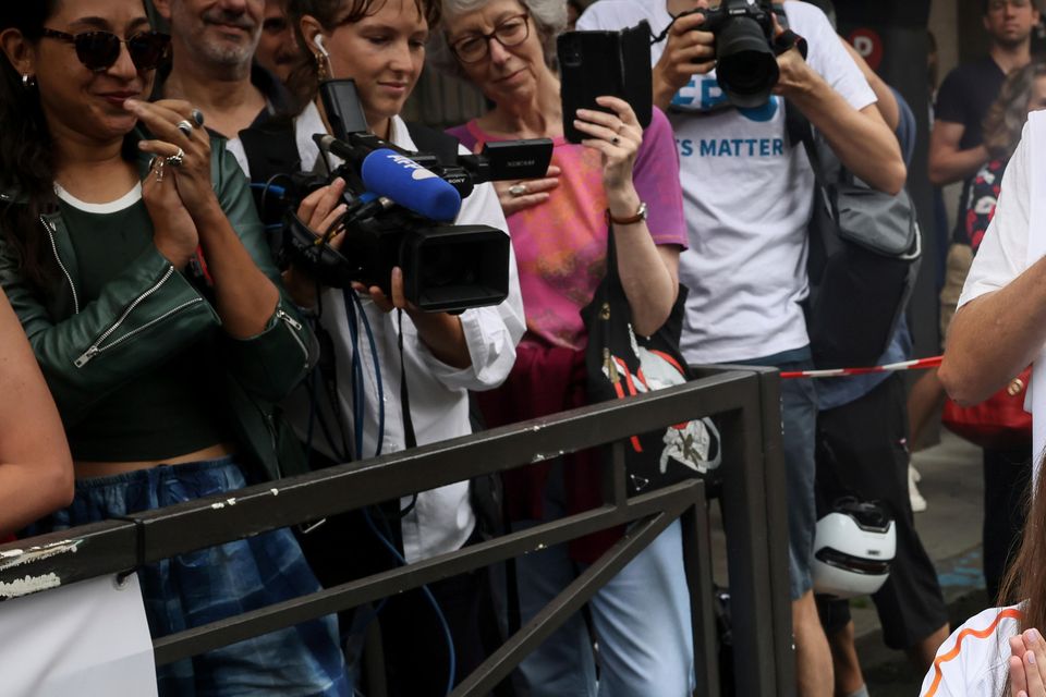 Press agency photographer Christina Assi arrives for the Olympic torch relay in Vincennes, outside Paris (Thomas Padilla/AP)